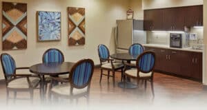 A sitting area with a fridge at Houston Transitional Care